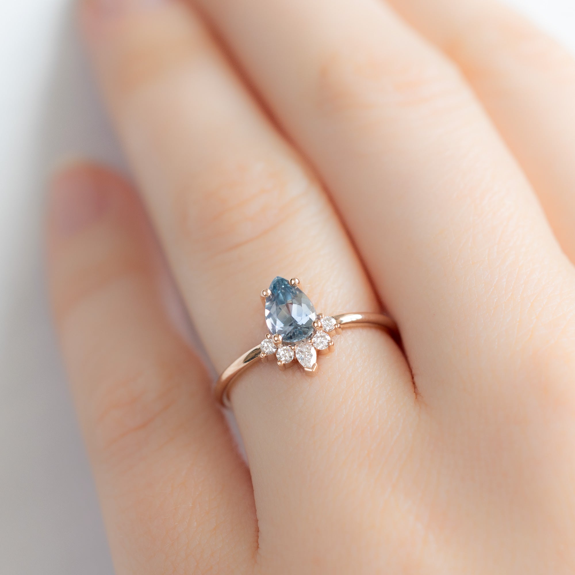 The Aster Ring with a Pear Blue Sapphire in 14K Rose Gold on Model