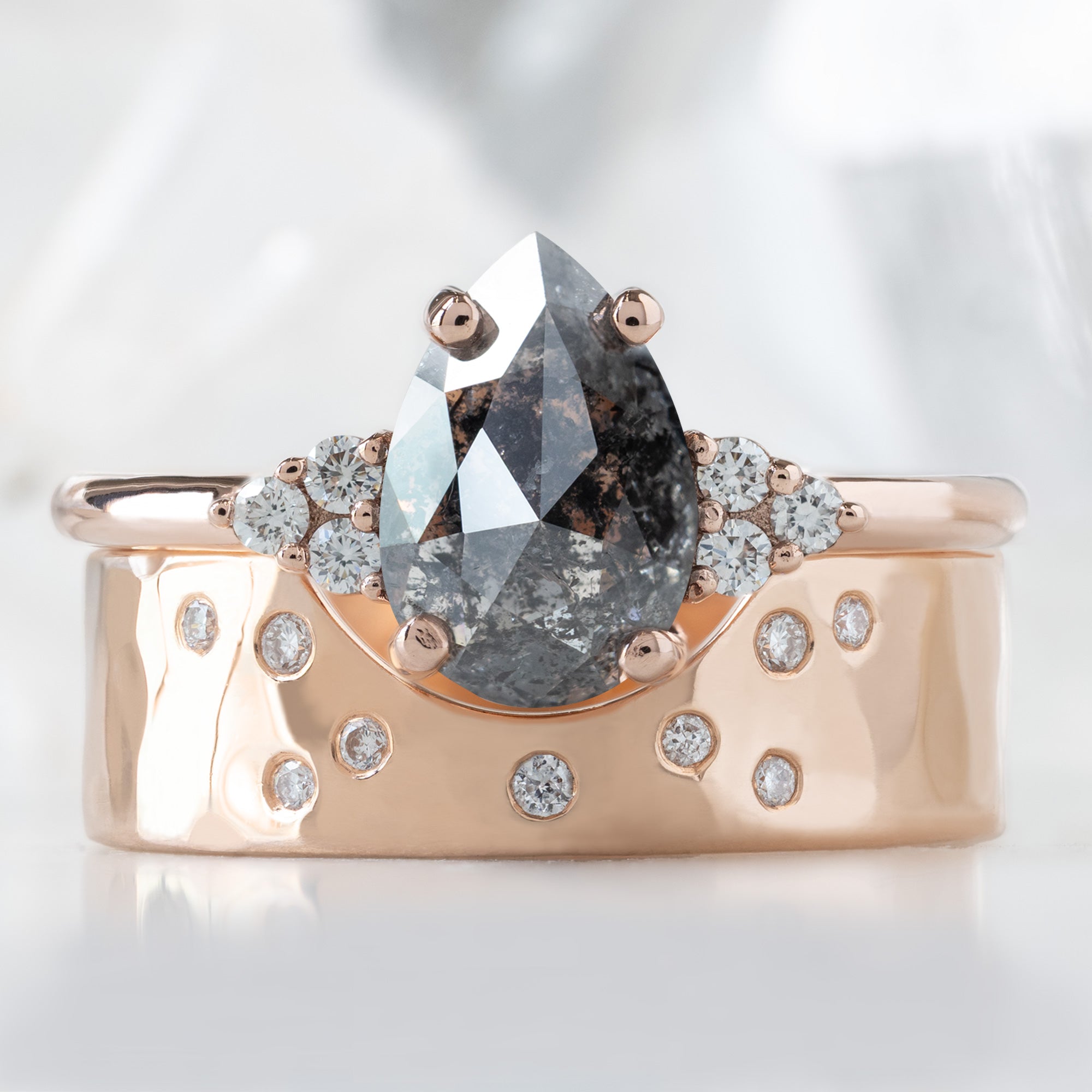 The Ivy Ring with a 1.54ct Pear Salt and Pepper Diamond in 14K Rose Gold Stacked with the Constellation Arc Stacking Band