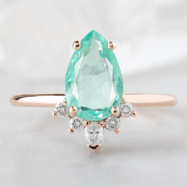 The Aster Ring with a 1.48ct Pear Emerald in 14K Rose Gold on White Marble