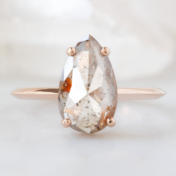 The Bryn Ring with a 1.76ct Pear Pink Diamond in 14K Rose Gold on White Marble Surface