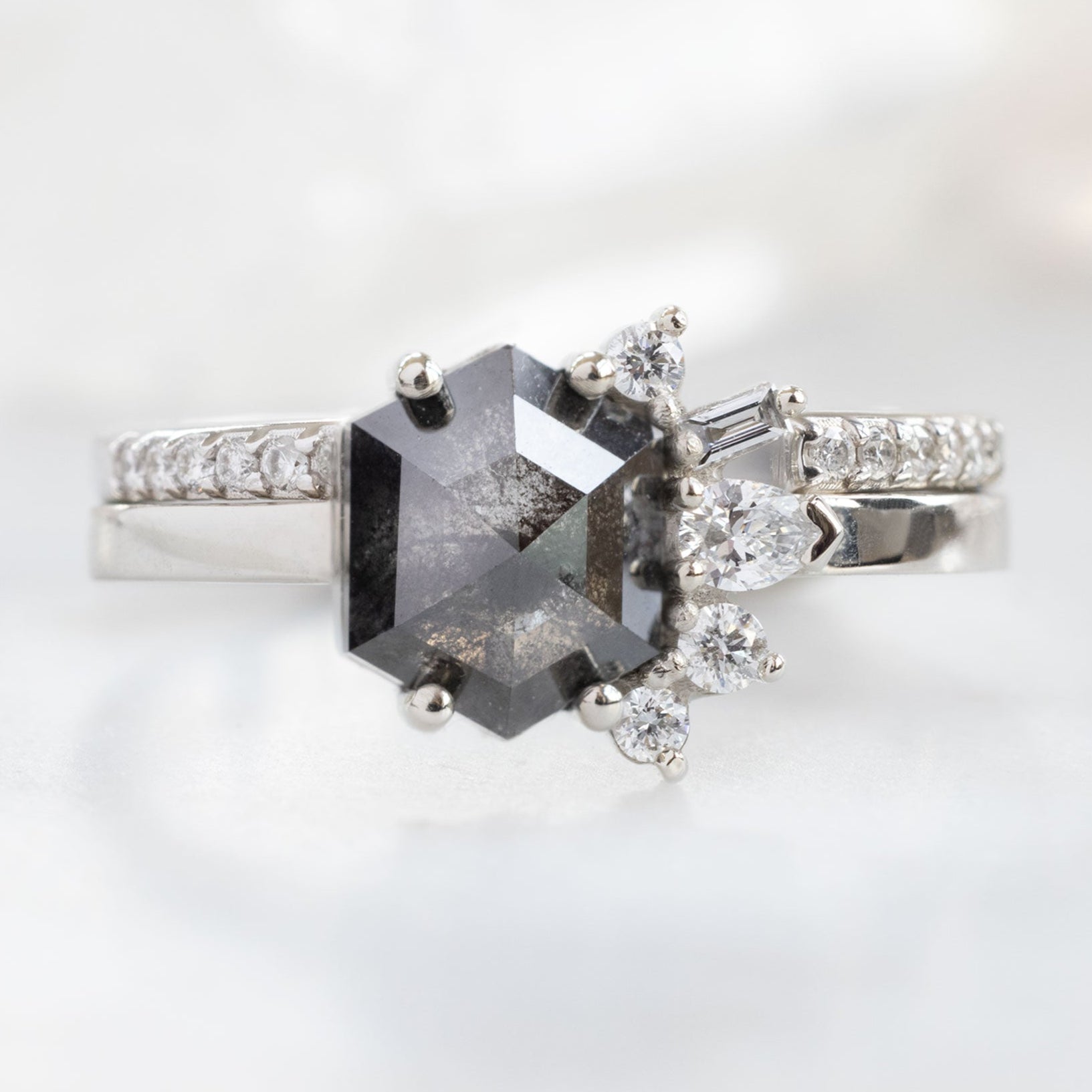 The Cluster Ring with a 1.25ct Hexagon Black Diamond in 14K White Gold Stacked with the Open Cuff White Diamond Pavé Stacking Band