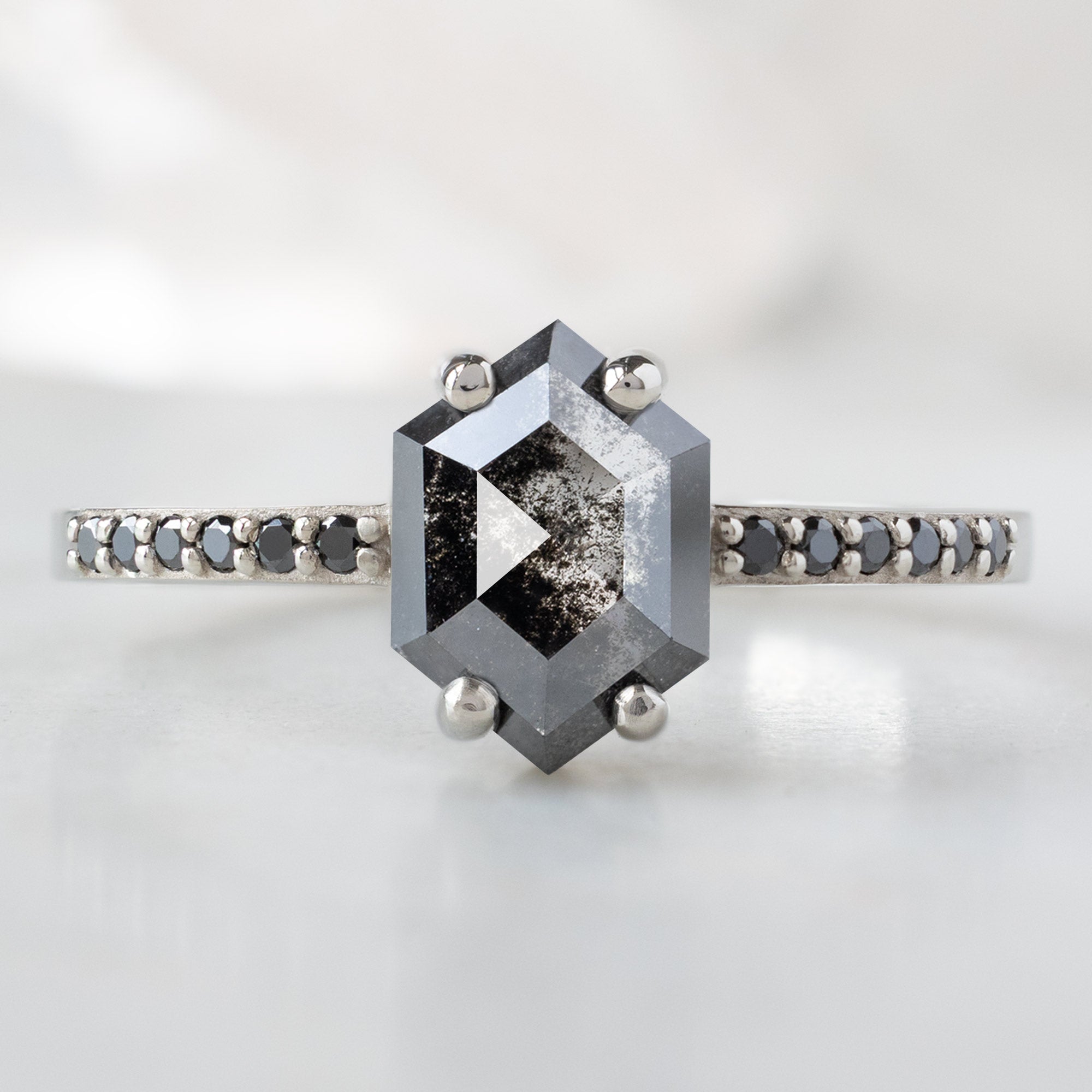 The Willow Ring with a 0.89ct Hexagon Black Diamond in 14K White Gold on White Marble