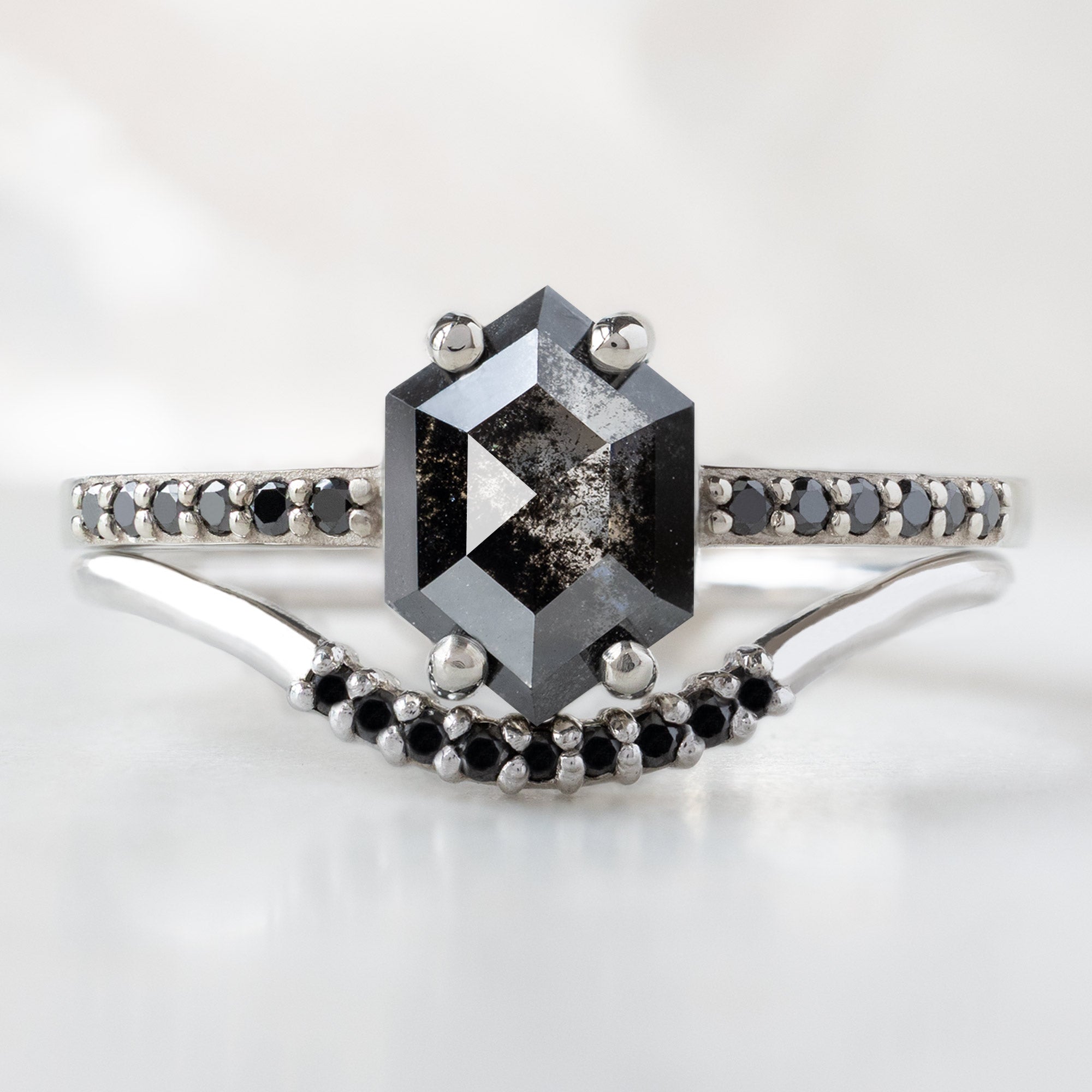 The Willow Ring with a 0.89ct Hexagon Black Diamond in 14K White Gold Stacked with the Black Pavé Diamond Arc Stacking Ring