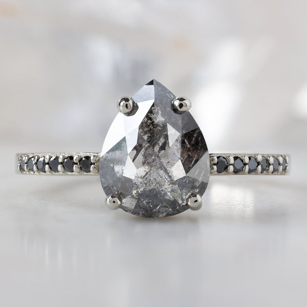 The Willow Ring with a 1.54ct Pear Black Diamond in 14K White Gold on White Marble