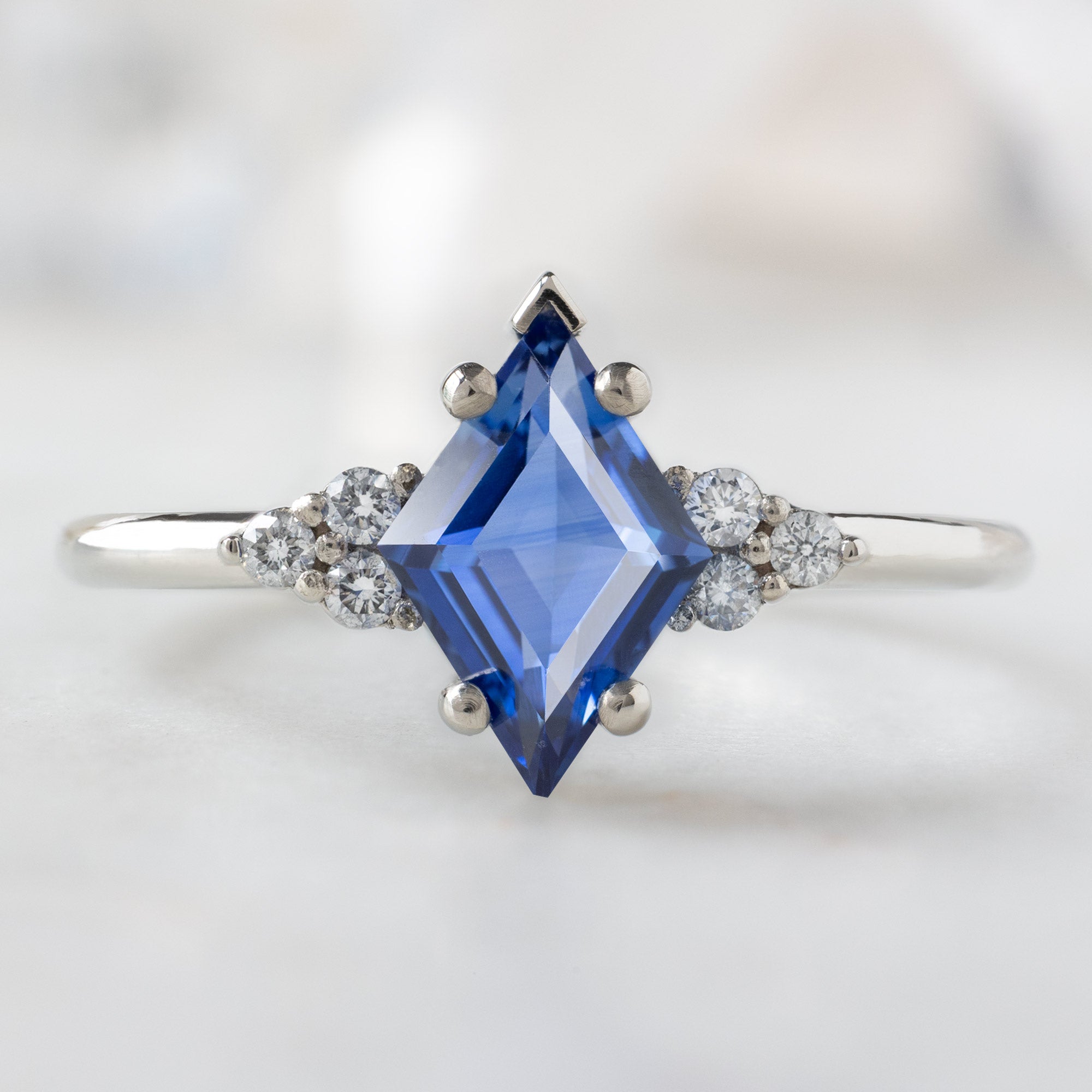 The Ivy Ring with a 1.04ct Kite Blue Sapphire in 14K White Gold on White Marble