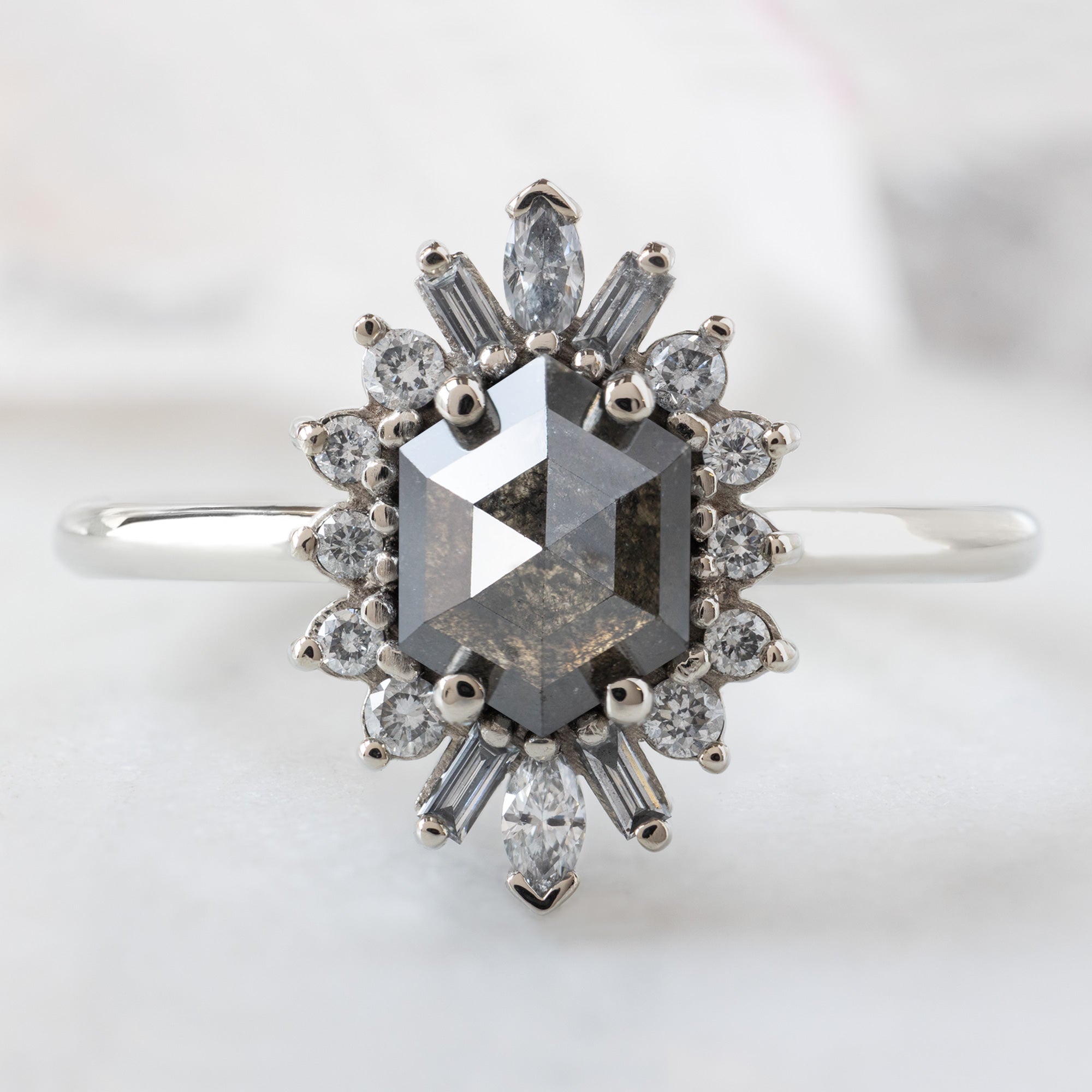 The Camellia Ring with a 0.94ct Hexagon Black Diamond in 14K White Gold on White Marble