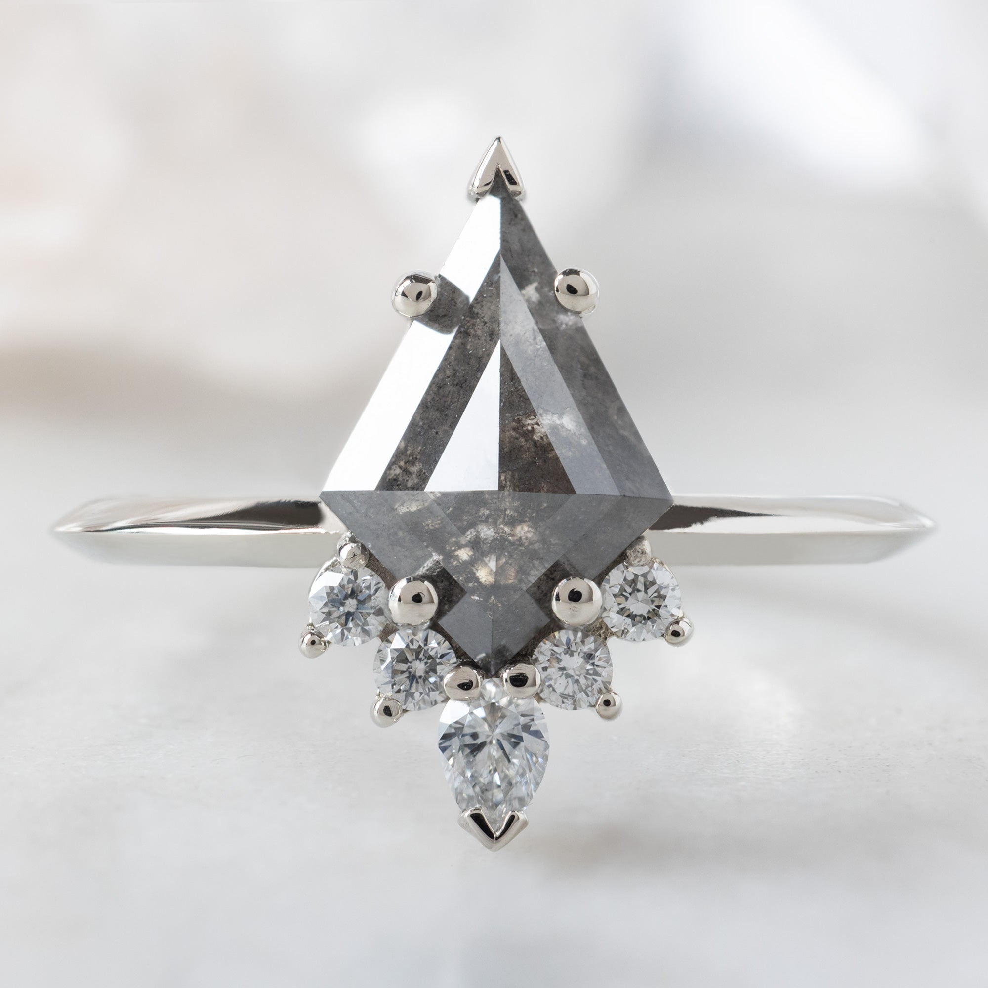 The Aster Ring with a 1.27ct Kite Black Diamond in 14K White Gold on White Marble