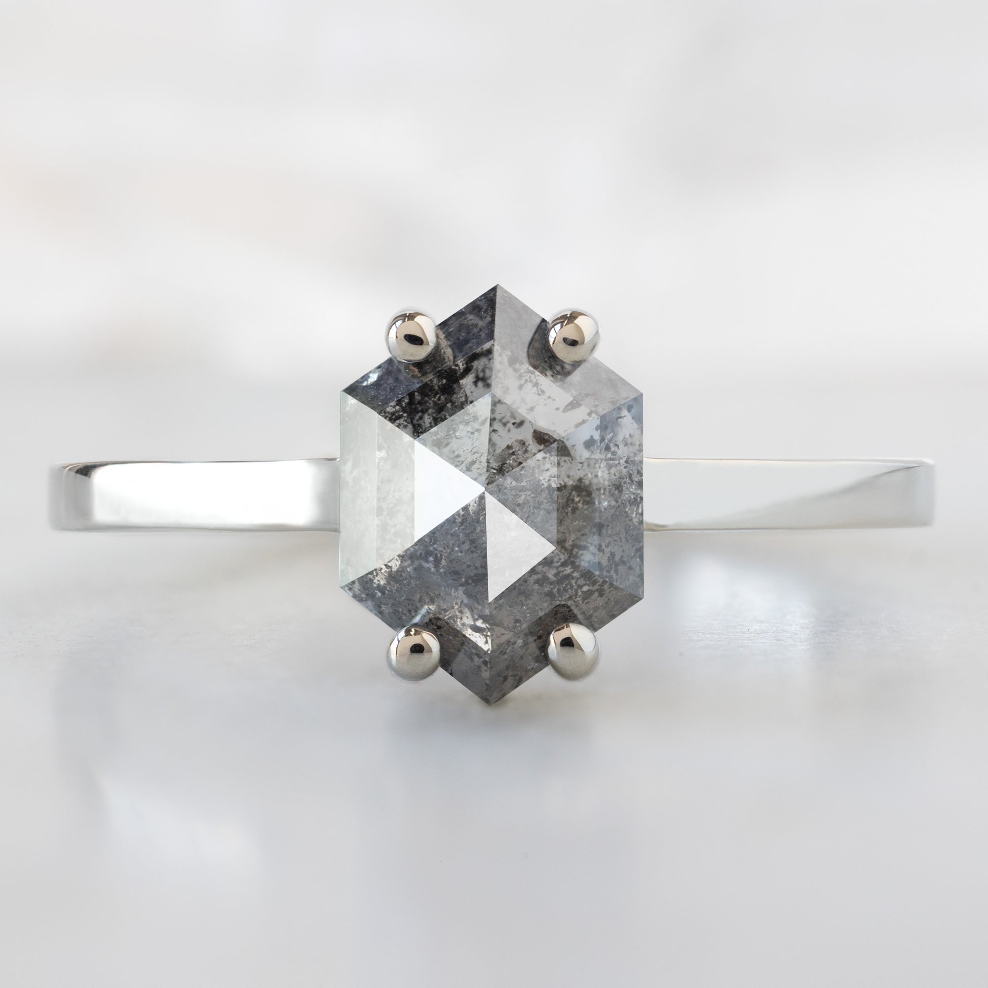 The Bryn Ring with a 1.37ct Hexagon Salt and Pepper Diamond in 14K White Gold on White Marble Tile