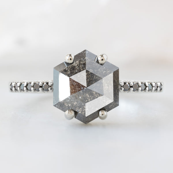 The Willow Ring with a 1.34ct Hexagon Black Diamond in 14K White Gold on White Marble Surface