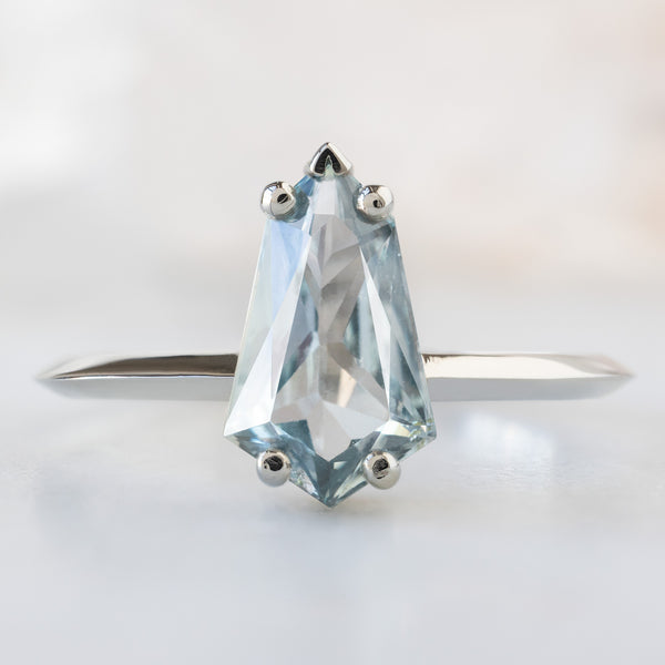 The Sage Ring with a 1.44ct Geometric Blue Sapphire in 14K White Gold on White Marble Surface