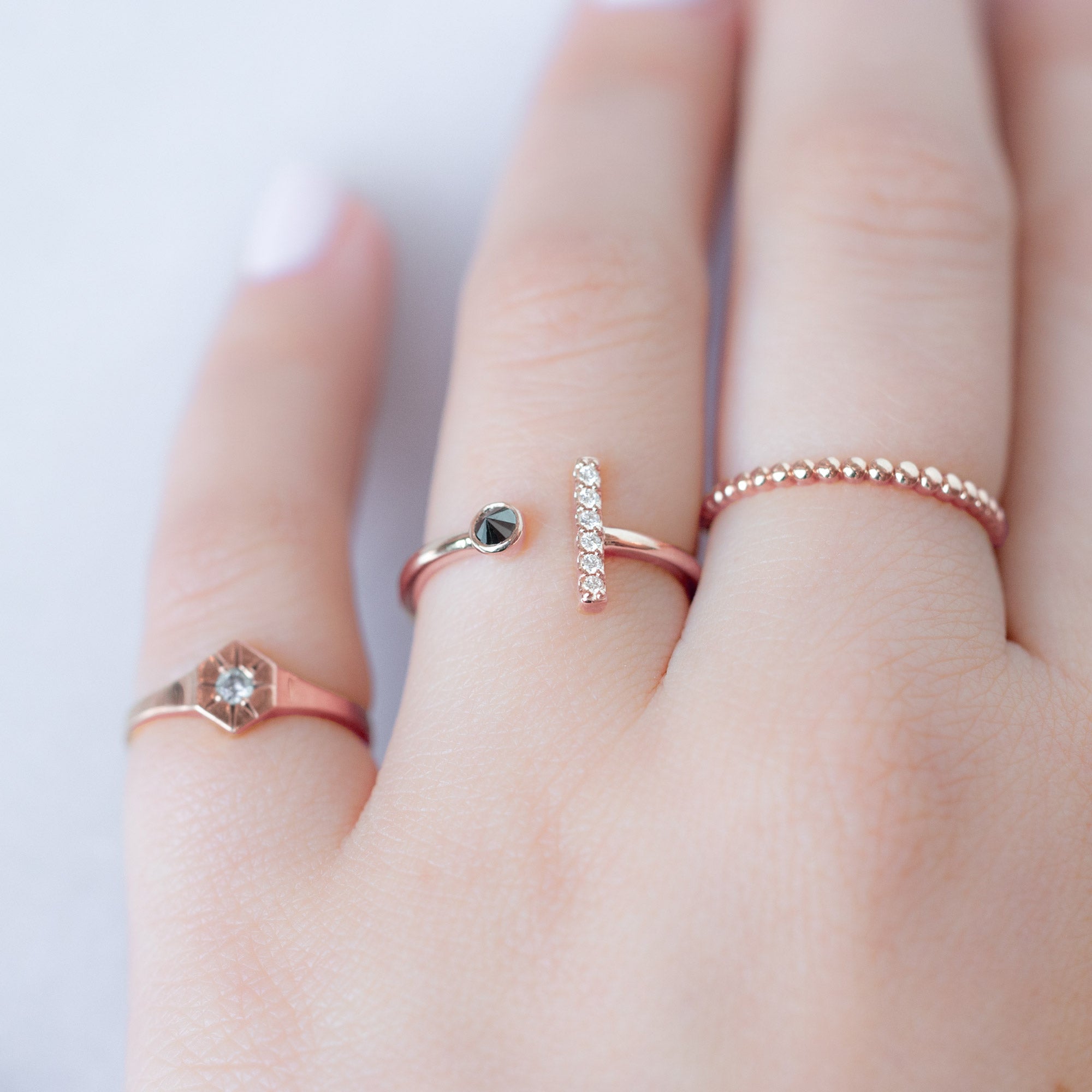 buy:custom-white-diamond-birthstone-signet-ring-10k-yellow-gold,the-black-white-diamond-linea-ring-14k-rose-gold,the-gold-beaded-stacking-ring-14k-yellow-gold