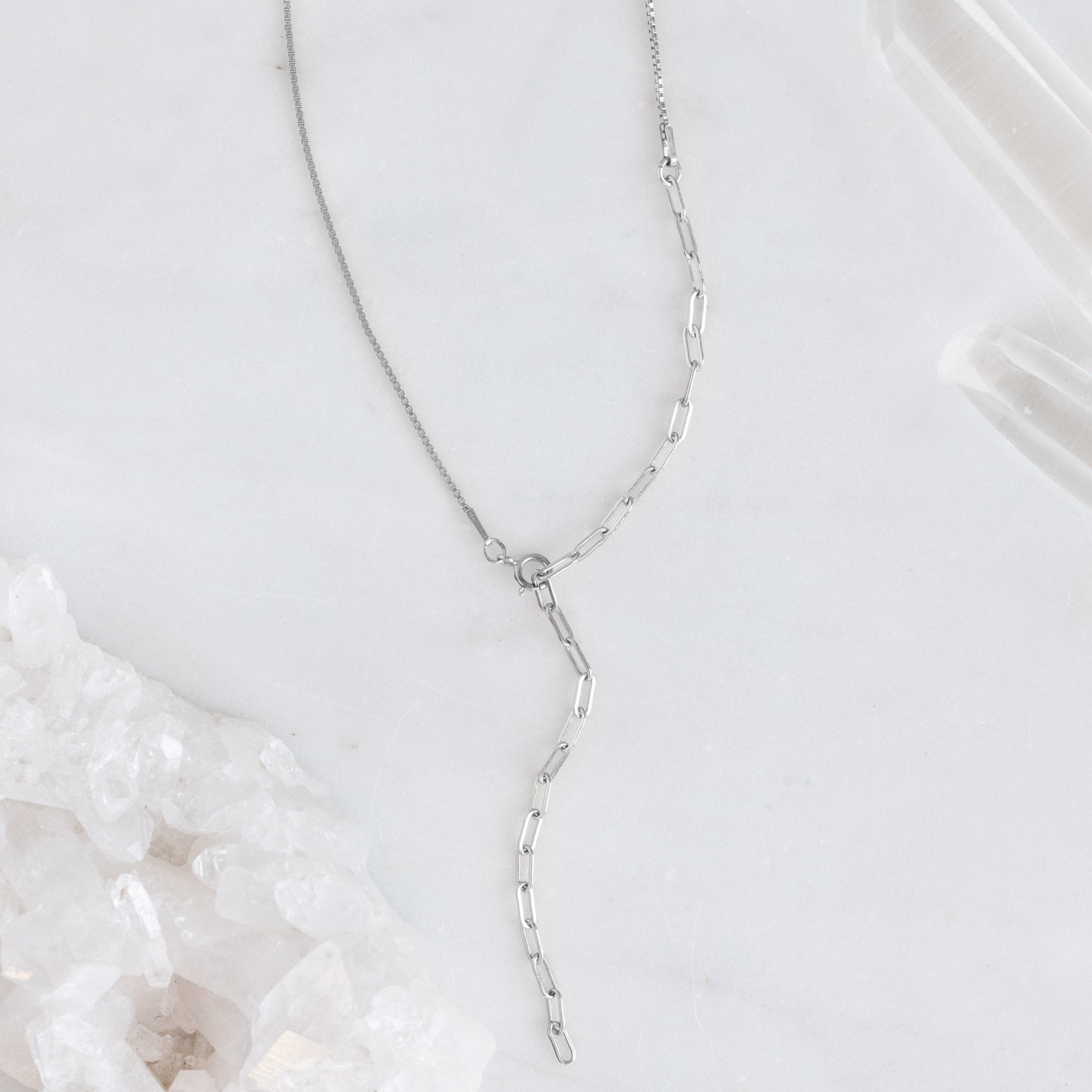 The 4-in-1 Cable Chain Necklace in 14K White Gold on White Marble Surface