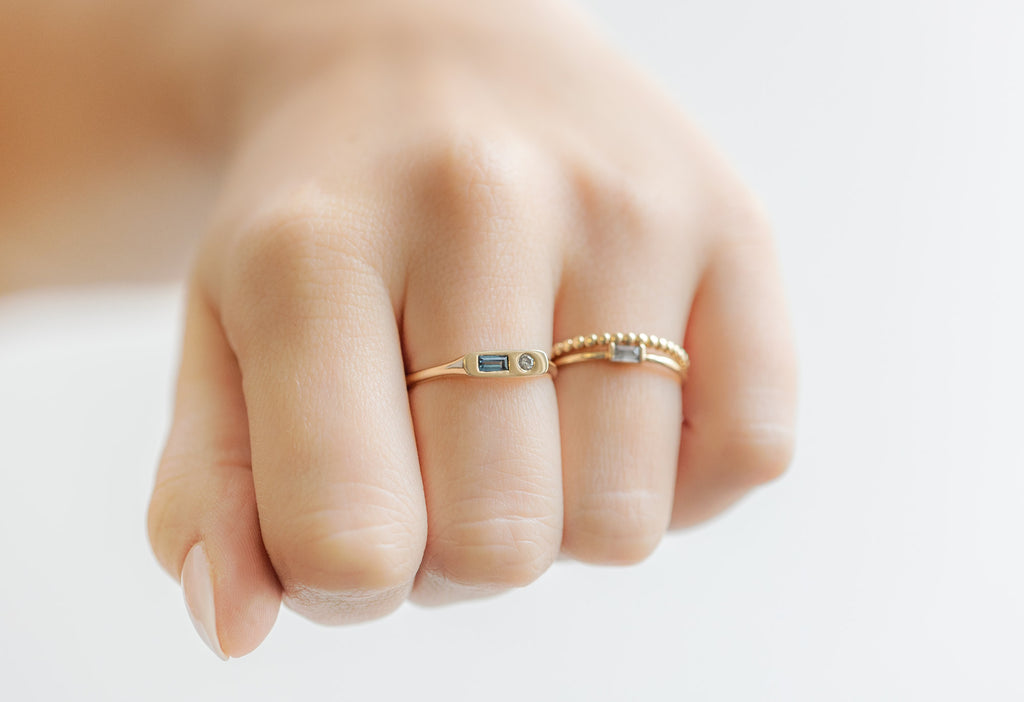Asymmetrical Sapphire + Diamond Signet Ring Stacked on Model Making a Fist