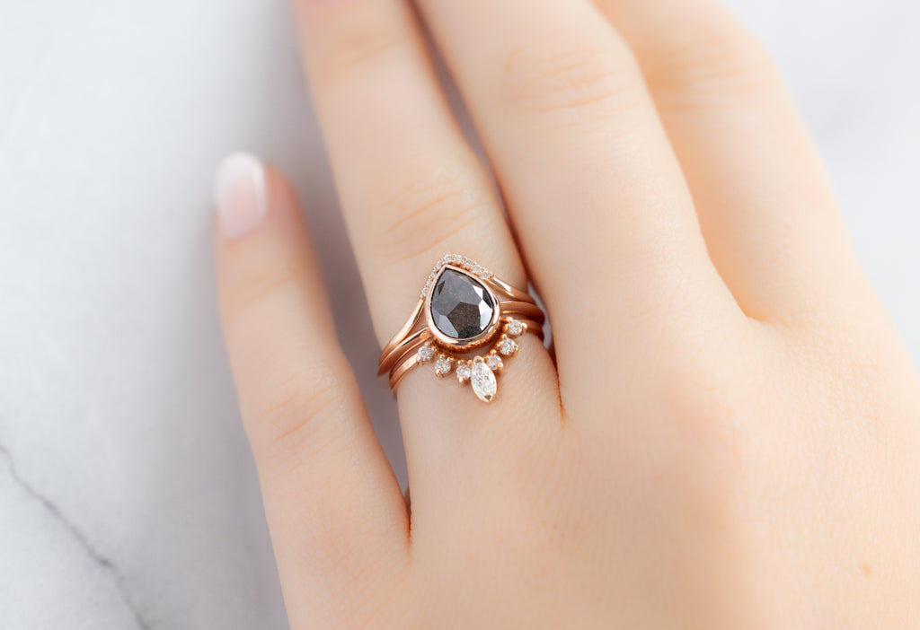 The Hazel Ring with a Rose-Cut Black Diamond with White Diamond Stacking Bands on Model