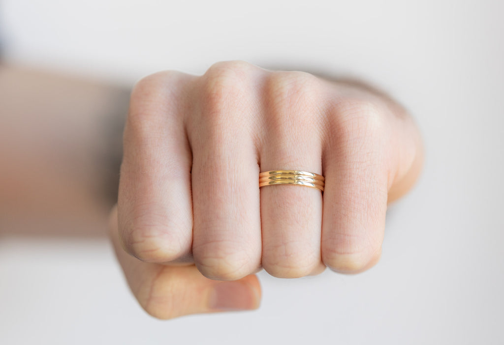 18k Yellow Gold Trio Stacking Ring on model making a fist