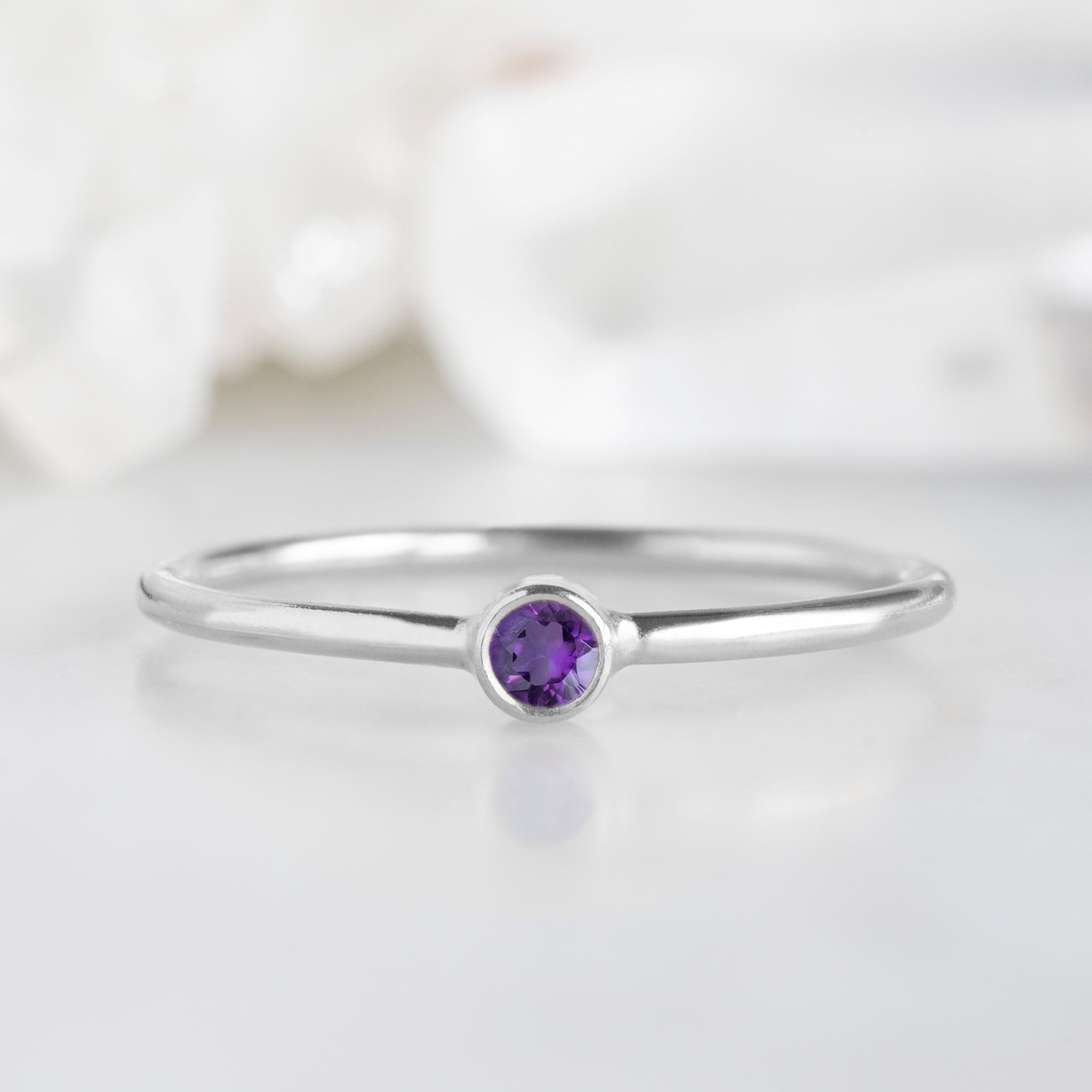 Custom Amethyst Birthstone Stacking Ring | 10K White Gold with white blurred background.