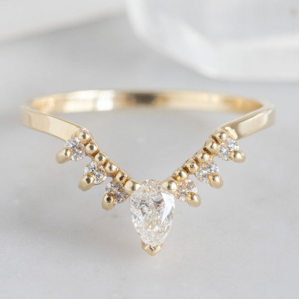 White Diamond Sunburst Stacking Band in 14K Yellow Gold on White Marble Tile