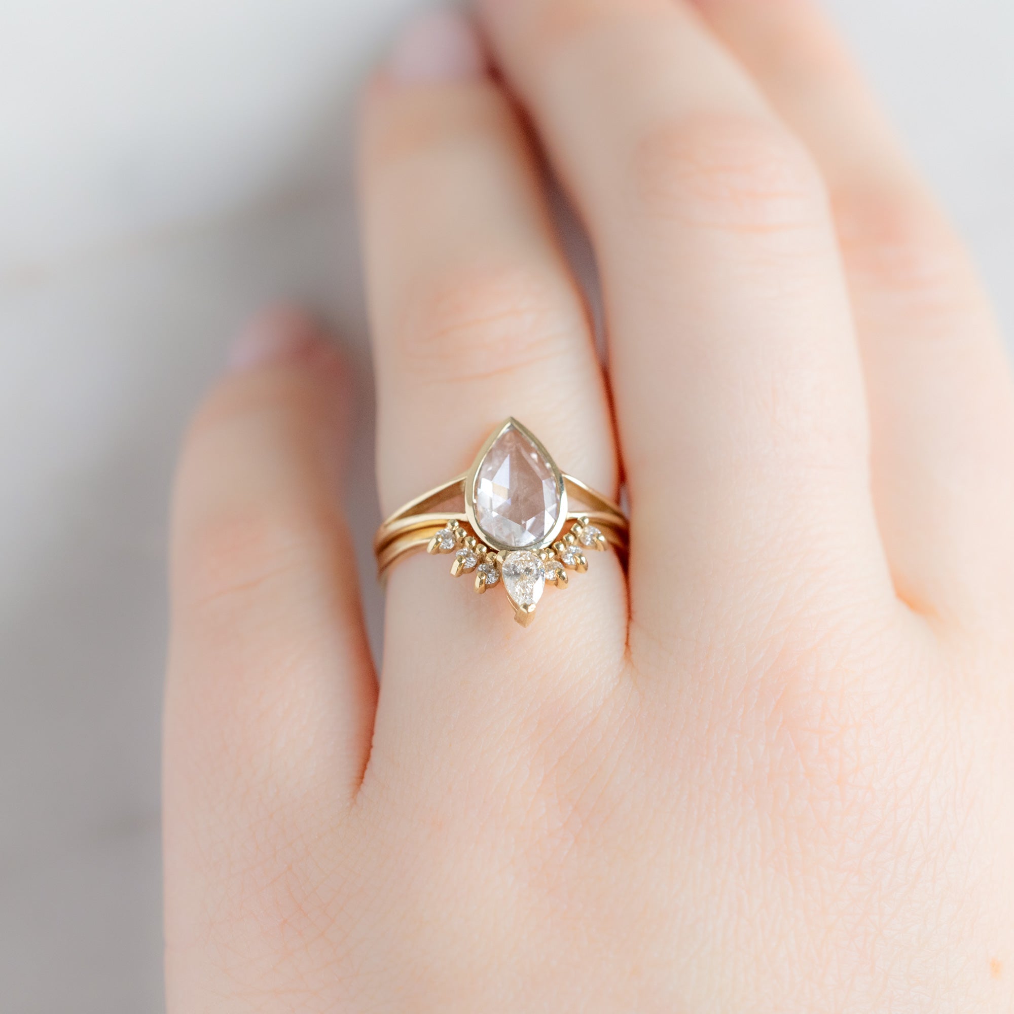 White Diamond Sunburst Stacking Band in 14K Yellow Gold Stacked with White Diamond Engagement Ring on Model