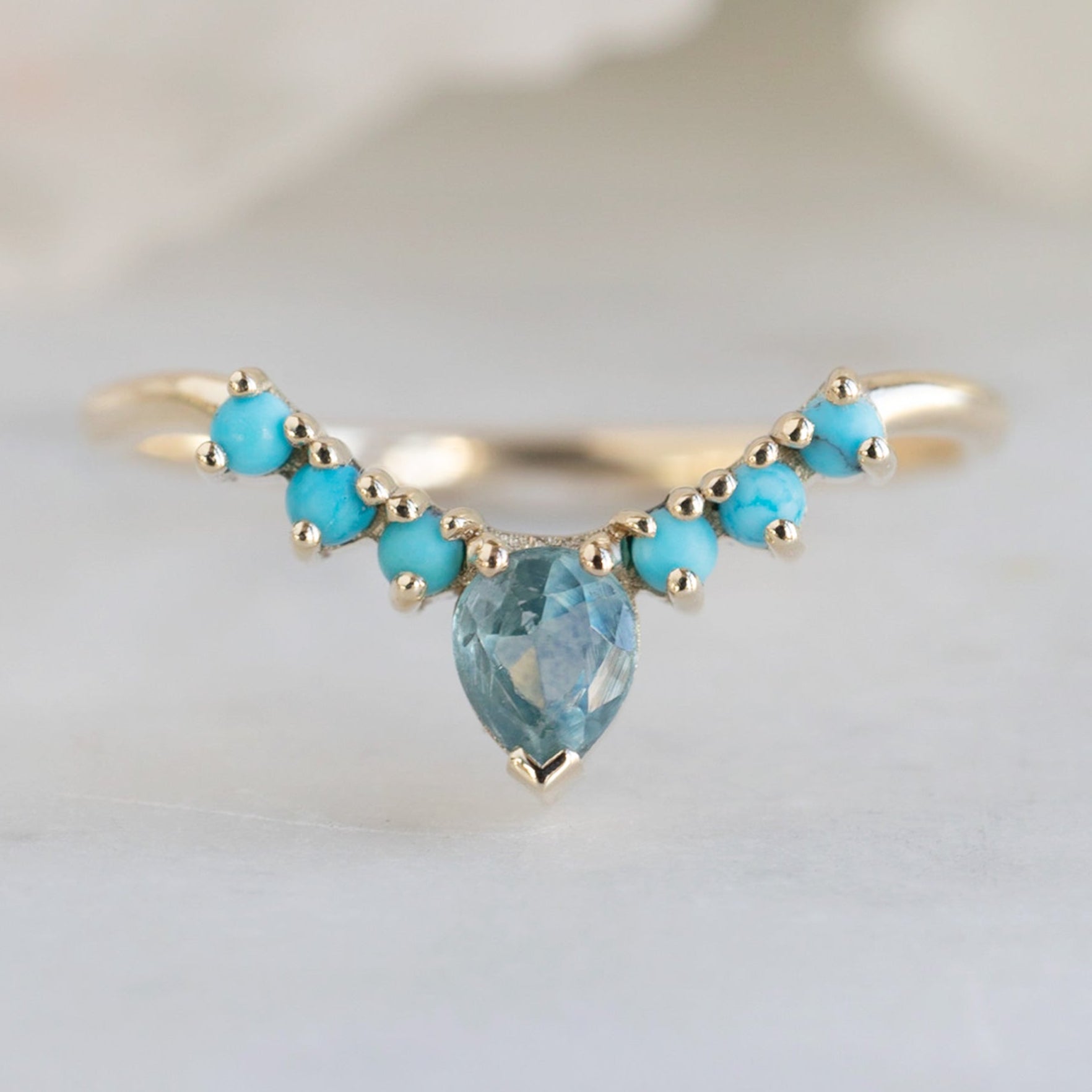 Montana Sapphire and Turquoise Sunburst Stacking Band in 14K Yellow Gold on White Marble