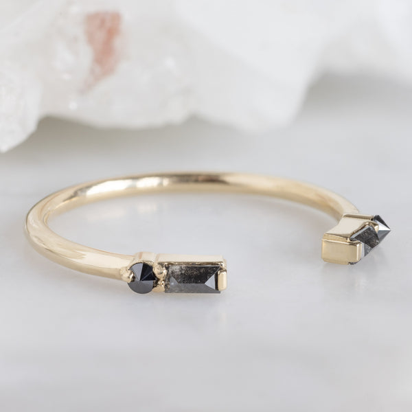 The Luxe Open Cuff Black Baguette Diamond Stacking Band in 14K Yellow Gold on White Marble