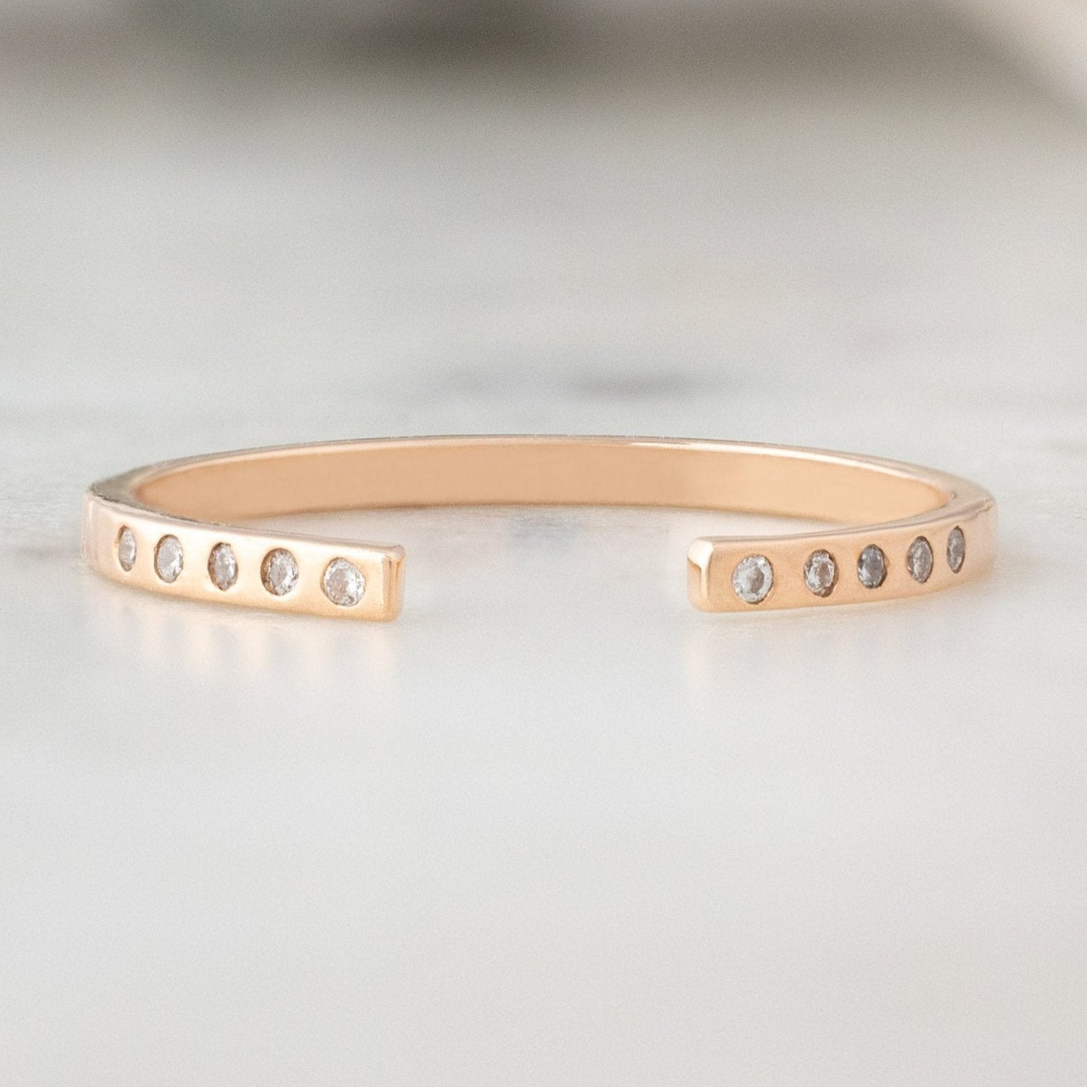 Open Cuff Flush Set Salt and Pepper Diamond Pavé Stacking Band in 14k Rose Gold on White Marble