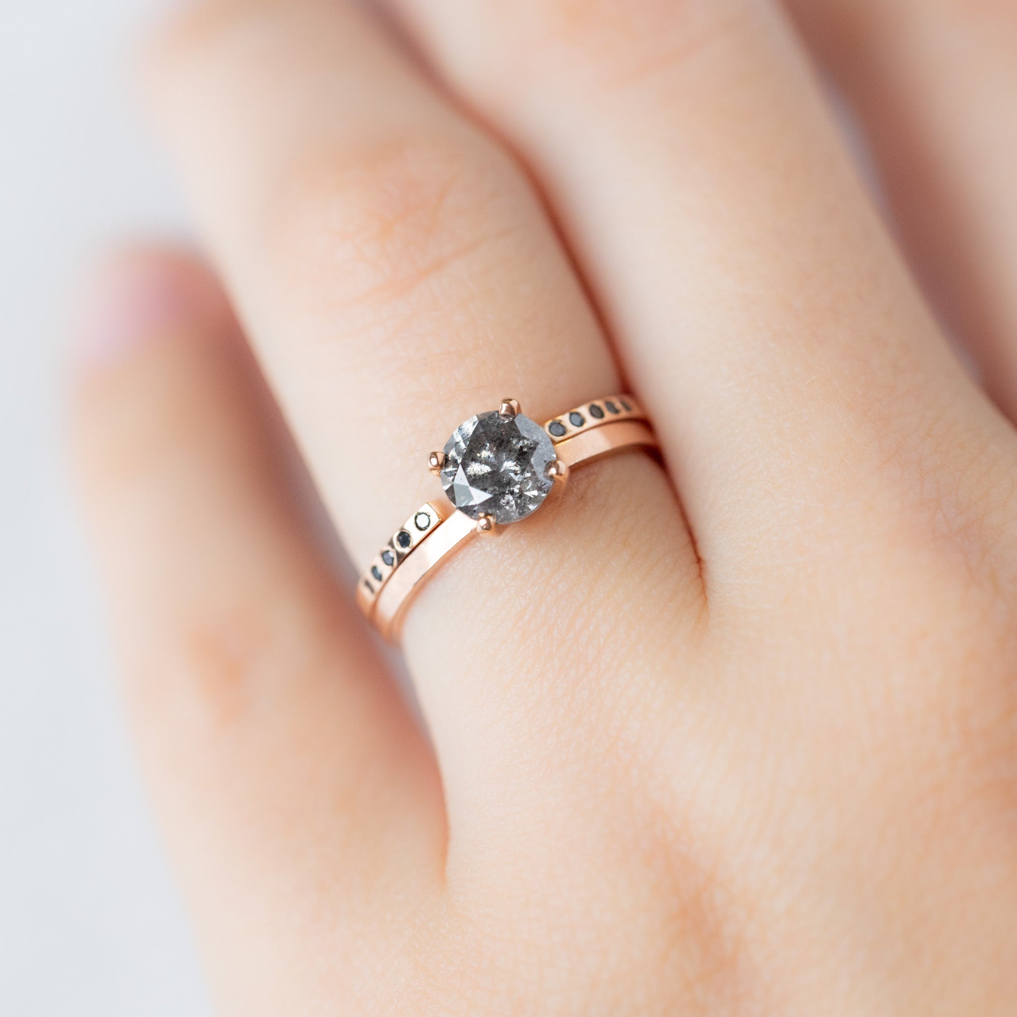 Open Cuff Flush Set Black Diamond Pavé Stacking Band in 14K Rose Gold Stacked with Round Salt and Pepper Diamond Solitaire Engagement Ring on Model