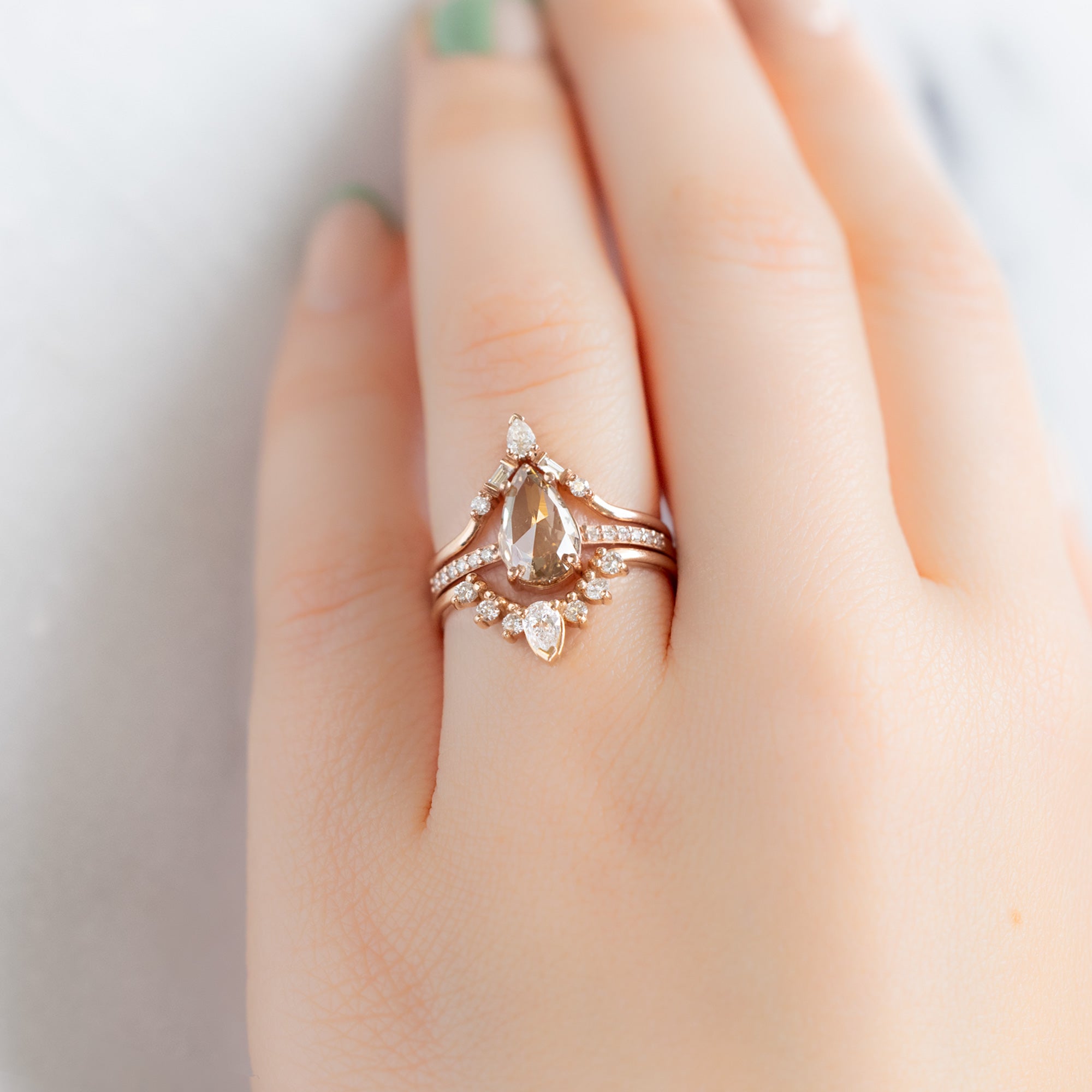 White Diamond Sunburst Stacking Band in 14K Rose Gold Stacked with Pink Diamond Pear Engagement Ring on Model