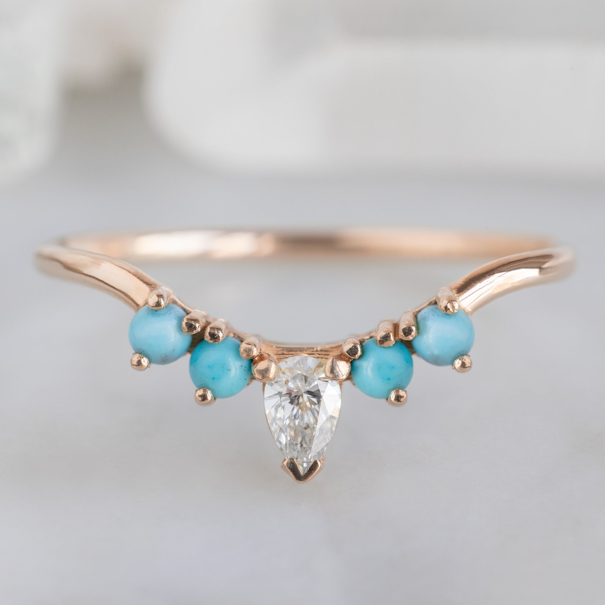 White Diamond and Turquoise 4-Stone Sunburst Stacking Band in 14K Rose Gold on White Marble Tile
