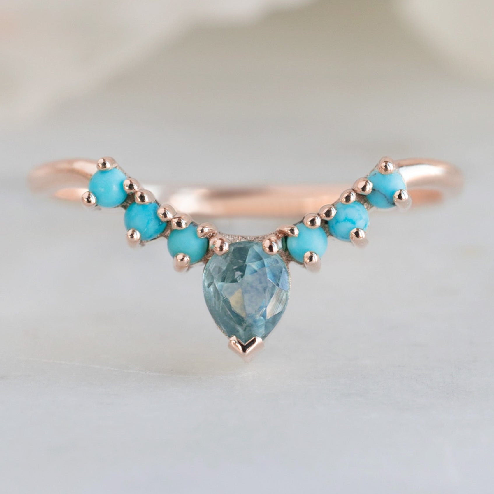 Montana Sapphire and Turquoise Sunburst Stacking Band in 14K Rose Gold on White Marble Tile
