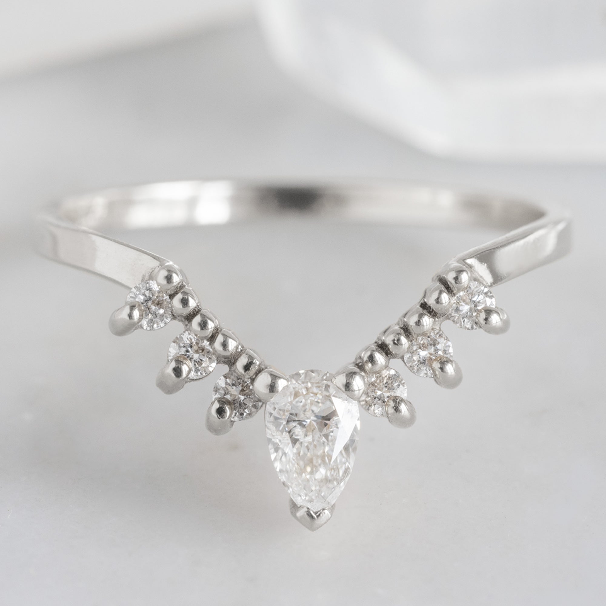 White Diamond Sunburst Stacking Band in 14K White Gold on White Marble Tile