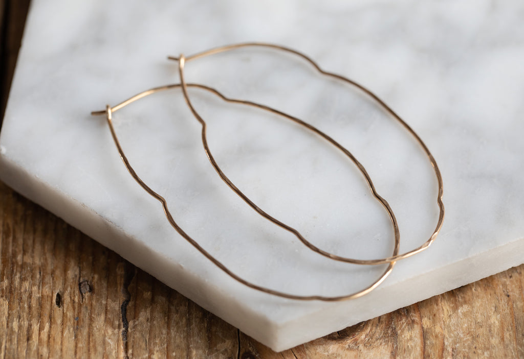 Organic Hoop Earrings on White Marble Tile
