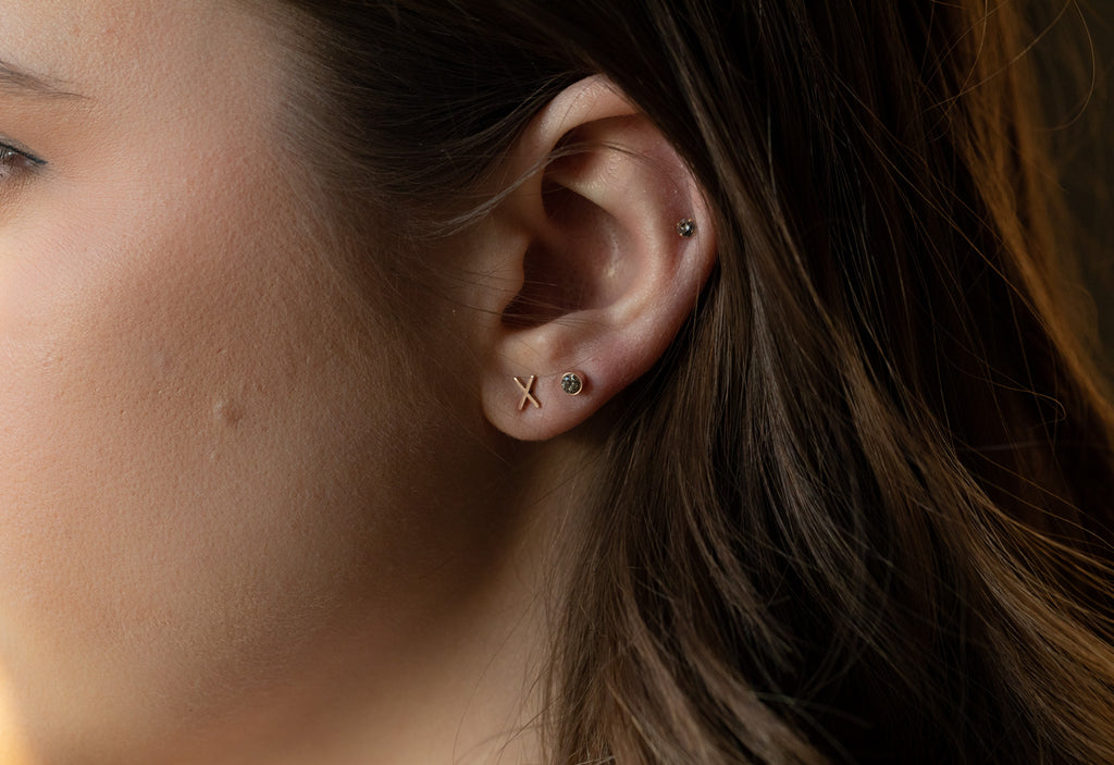 model wearing rose gold 'xo' diamond stud earrings