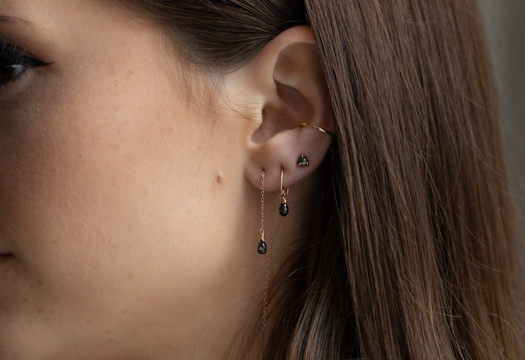 simple diamond drop threader earrings stacked on model