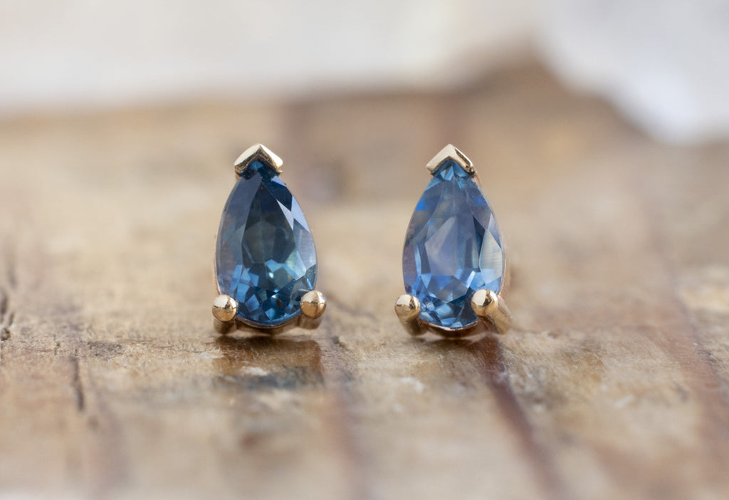 Montana Sapphire Stud Earrings in Yellow Gold on Wood Table