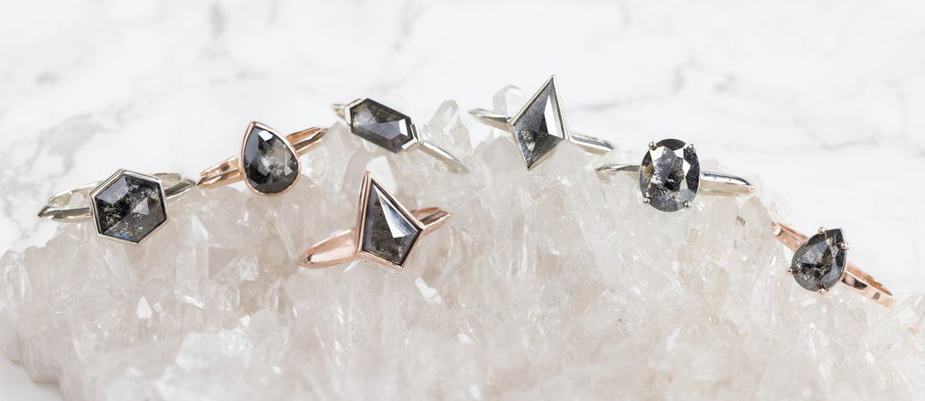 Black Diamond Engagement Rings Sitting on White Crystal