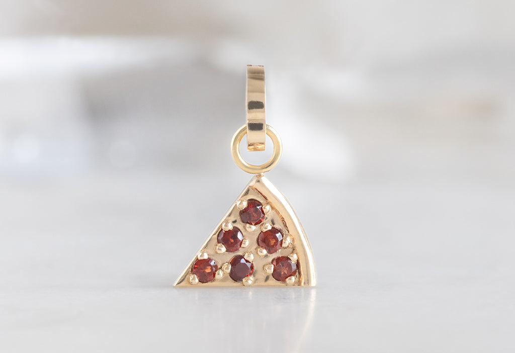 10k Yellow Gold Pizza Slice Charm on White Marble Tile
