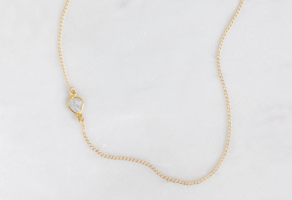 Yellow Gold Asymmetrical Diamond Slice Necklace on White Marble Tile