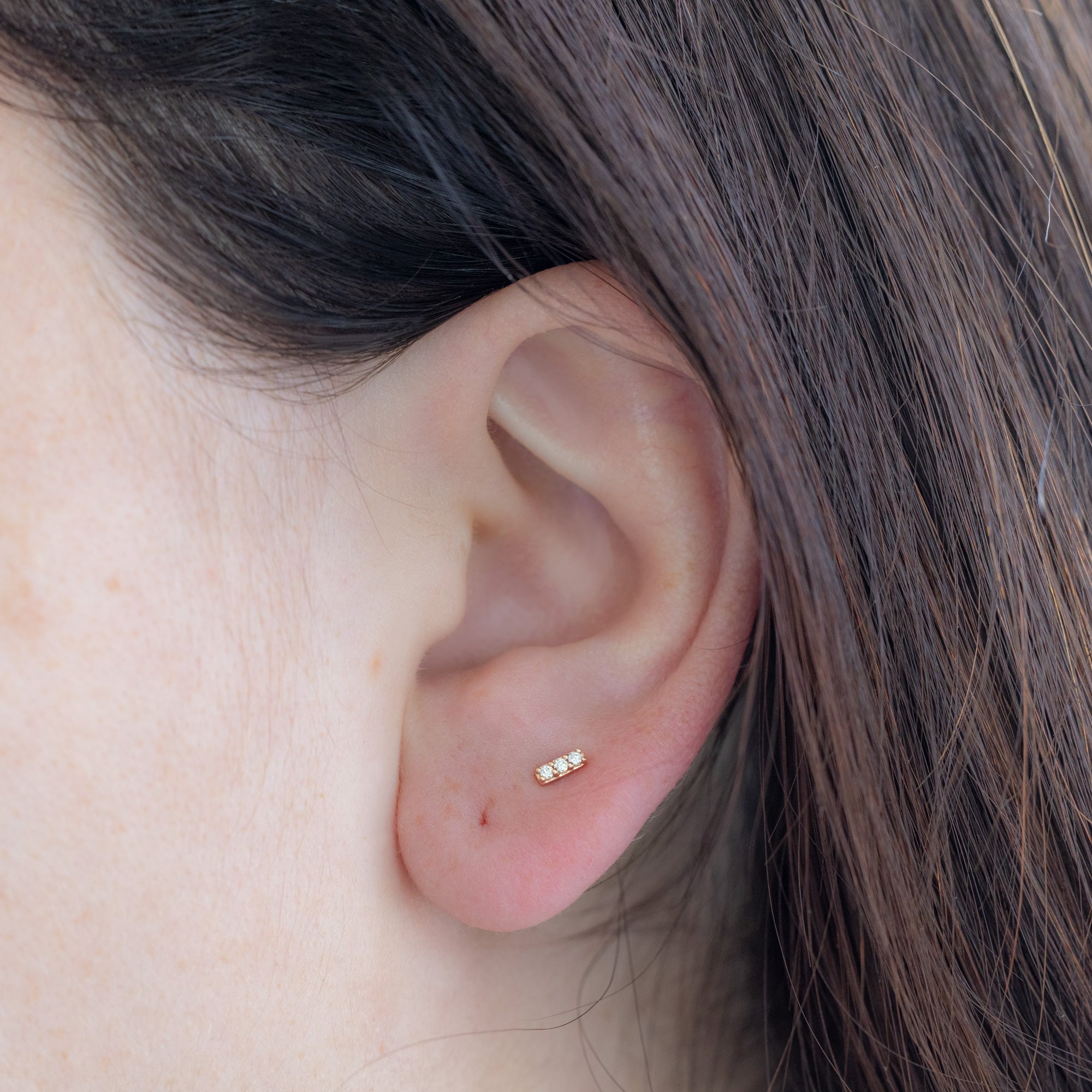The Teensy White Diamond Bar Studs in 14K Rose Gold on Model