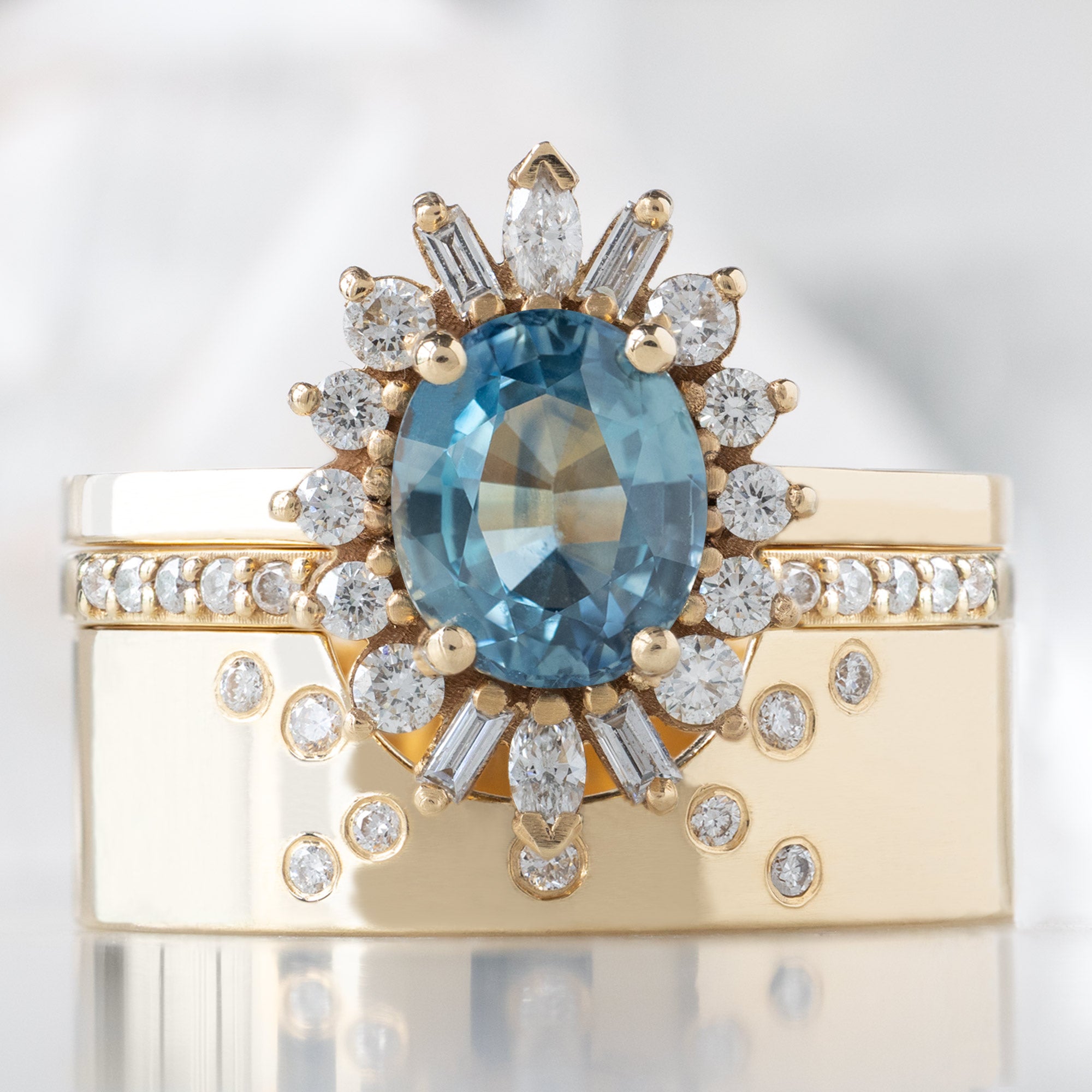 buy:the-camellia-ring-1-32ct-oval-blue-montana-sapphire-in-14k-yellow-gold,open-cuff-white-diamond-pave-stacking-band-14k-or-18k-yellow-gold,constellation-cut-out-stacking-band-arc-cut-out-in-14k-yellow-gold