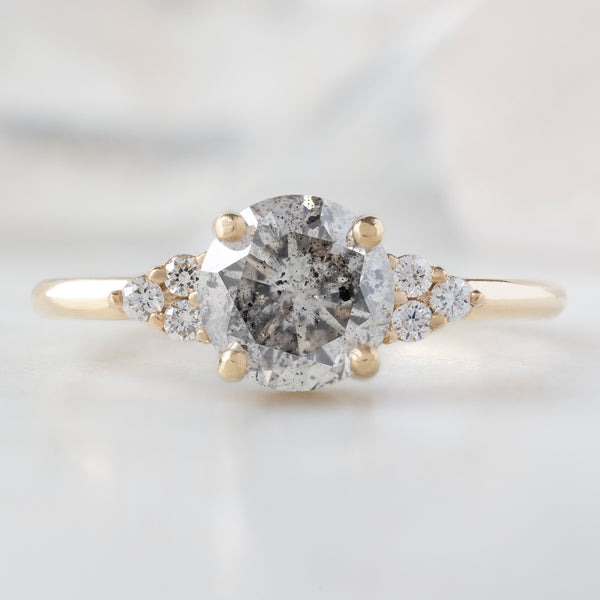 The Ivy Ring with a 1.01ct Round Salt and Pepper Diamond in 14K Yellow Gold on White Marble