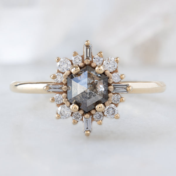 The Compass Ring with a 0.65ct Hexagon Salt and Pepper Diamond in 14K Yellow Gold on White Marble