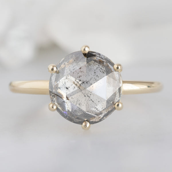 The Rose Ring with a 2.55ct Round Lab Grown Salt and Pepper Diamond in 14K Yellow Gold on White Marble