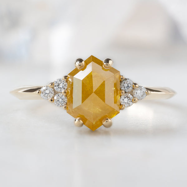 The Ivy Ring with a 1.48ct Hexagon Yellow Diamond in 14K Yellow Gold on White Marble