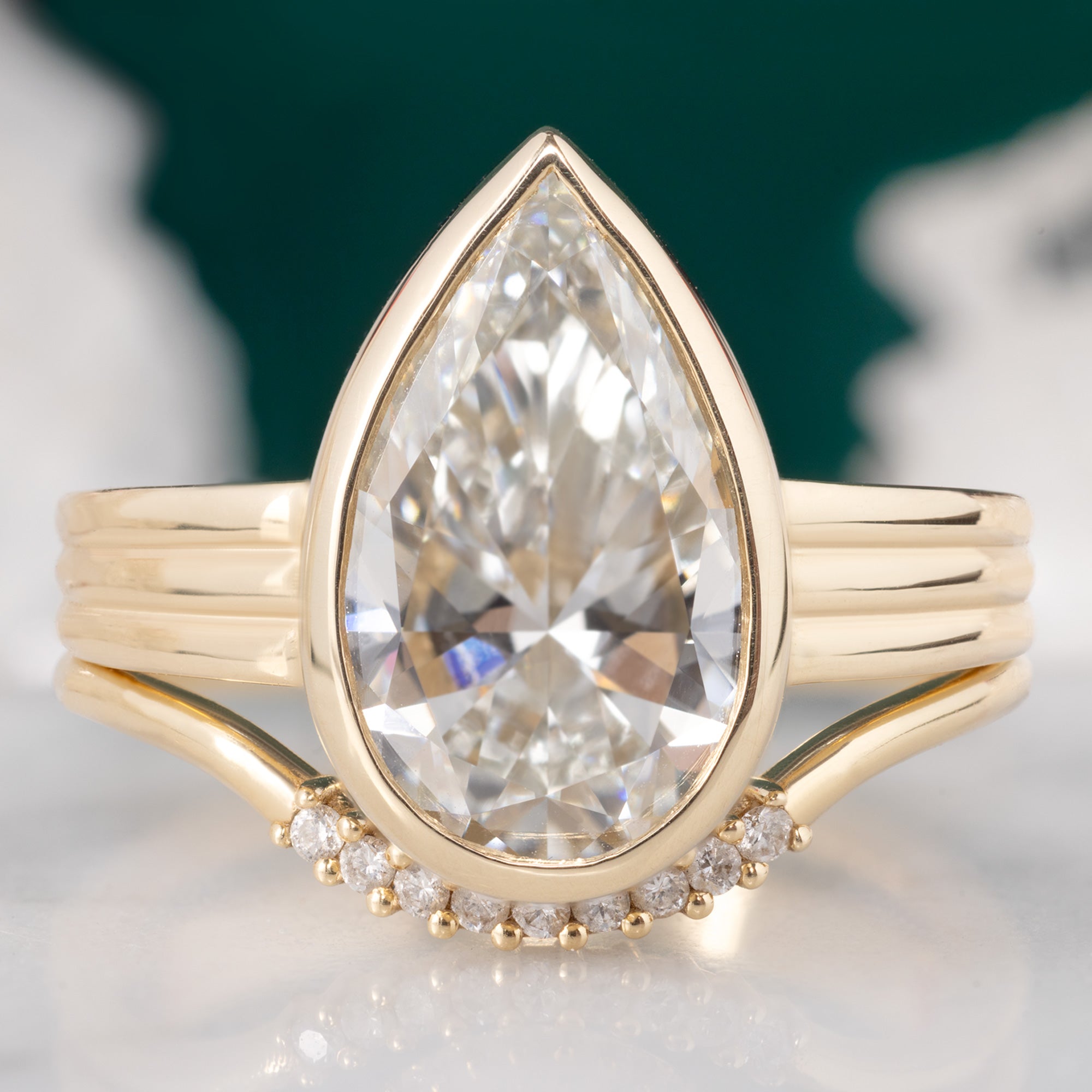 The Stratum Ring with a 3.02ct Pear Lab Grown White Diamond in 14K Yellow Gold Stacked with the White Diamond Pavé Arc Stacking Band