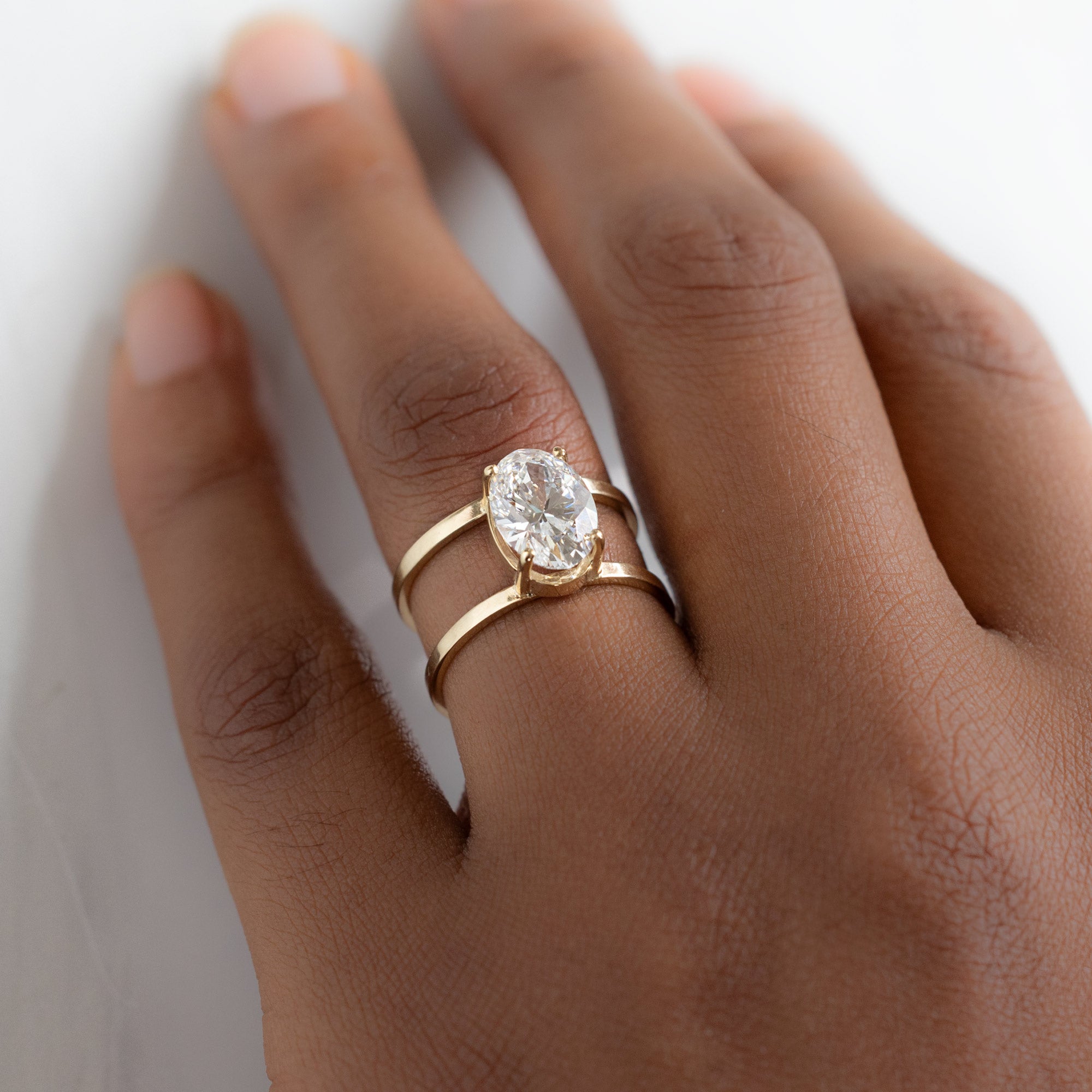 The Poppy Ring with a 3.06ct Oval Lab Grown White Diamond in 14K Yellow Gold on Model