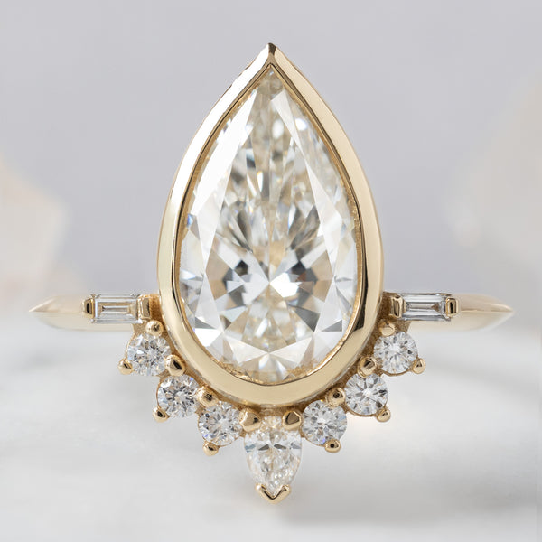 The Posy Ring with a2 .81ct Pear Lab Grown White Diamond in 14K Yellow Gold on White Marble