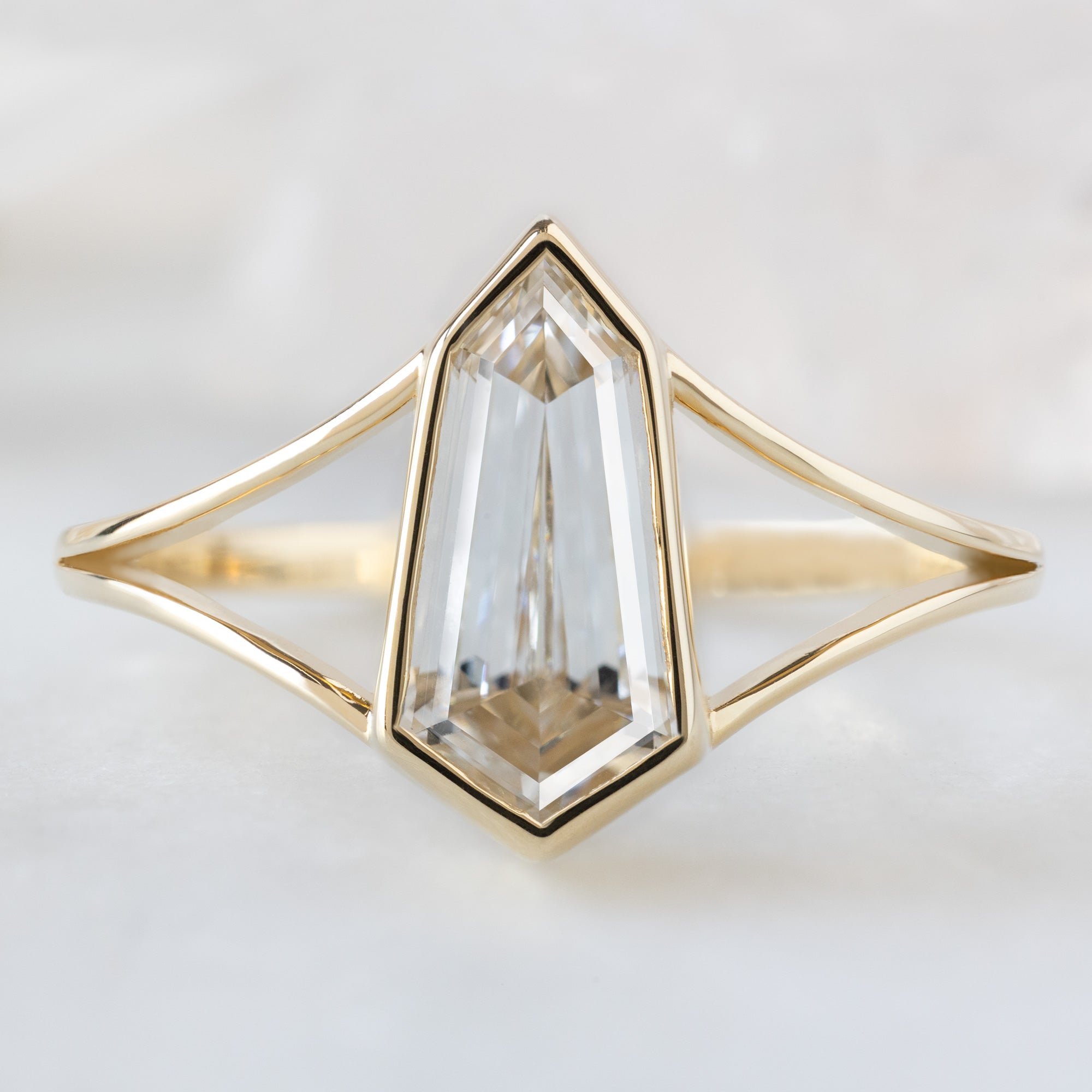 The Magnolia Ring with a 1.50ct Lab Grown Geometric White Diamond in 14K Yellow Gold on White Marble Tile