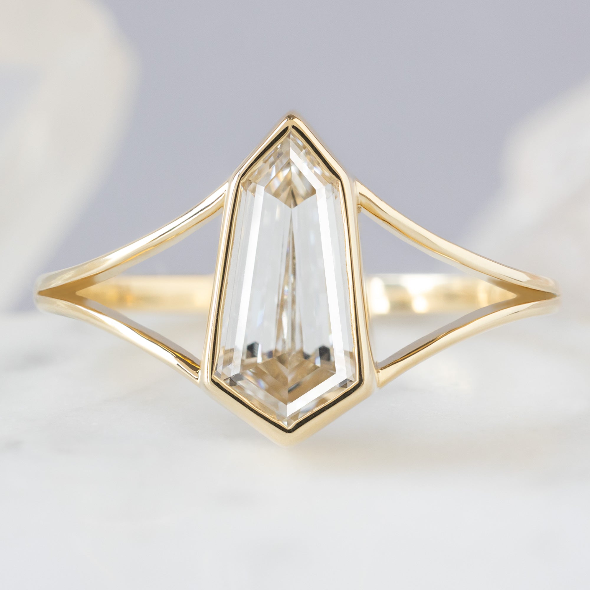 The Magnolia Ring with a 1.50ct Lab Grown Geometric White Diamond in 14K Yellow Gold on White Marble Tile