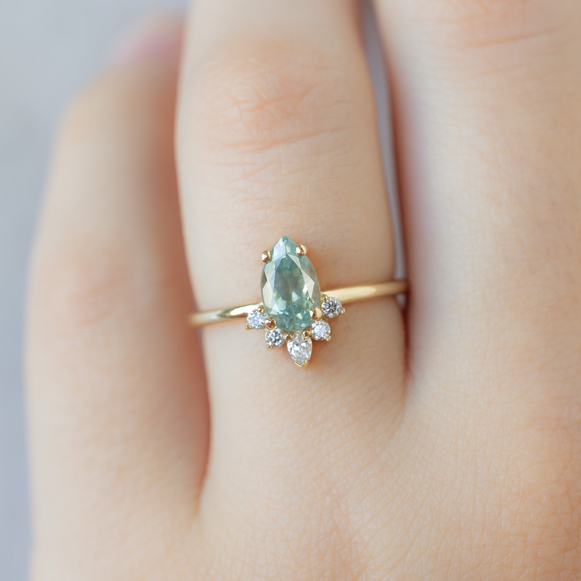 The Aster Ring with a 1.18ct Pear Blue Sapphire in 14K Yellow Gold on Model