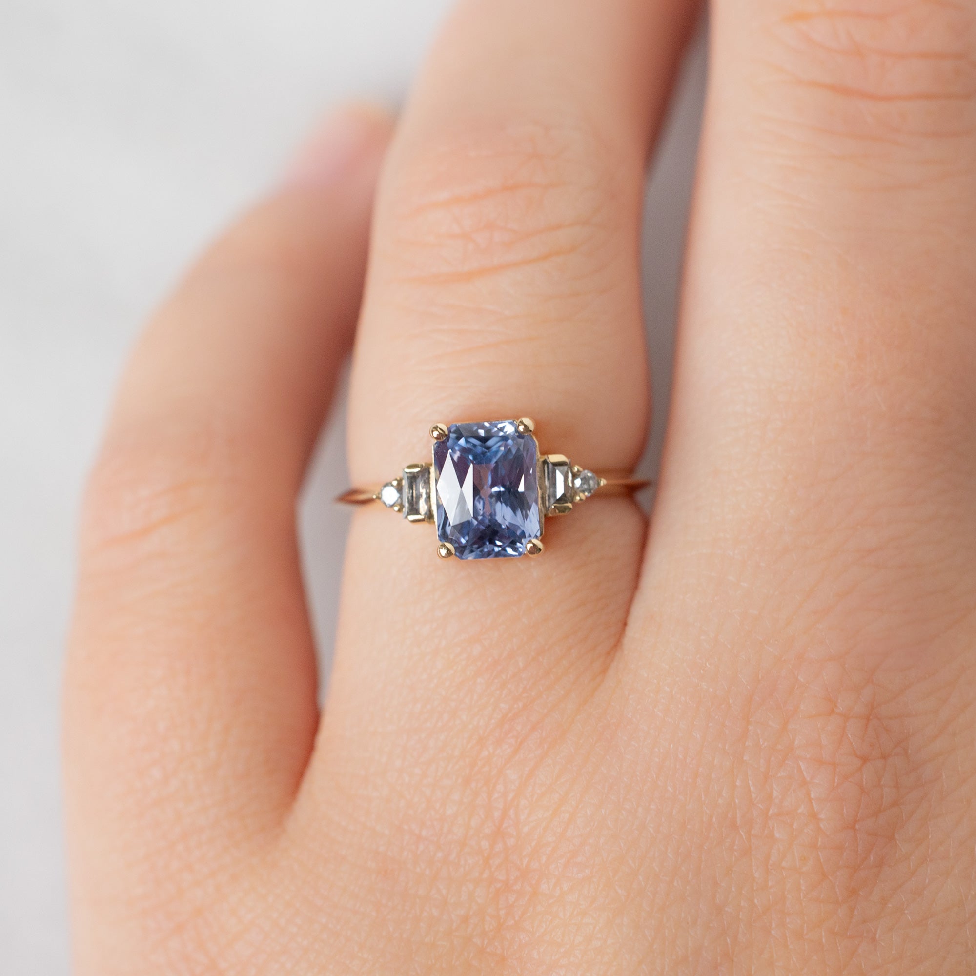 The Primrose Ring with a 2.36ct Emerald Cut Sapphire in 14K Yellow Gold on Model